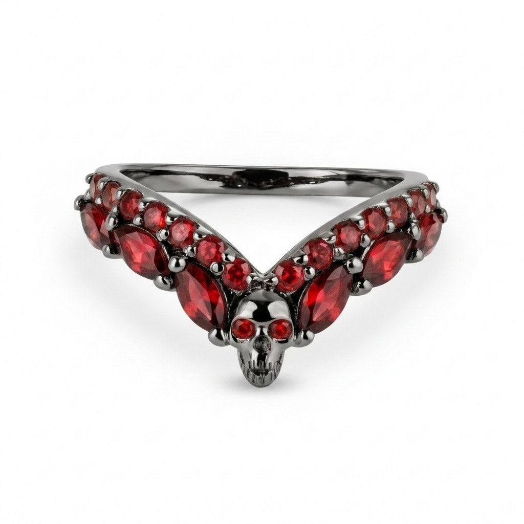 Alternative black wedding band featuring a central skull and V-shaped black onyx cubic zirconia gemstones