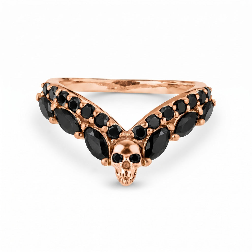V-shaped chevron skull wedding band in rose gold with black onyx accents, a unique gothic style ring enhancer perfect for alternative bridal jewelry.
