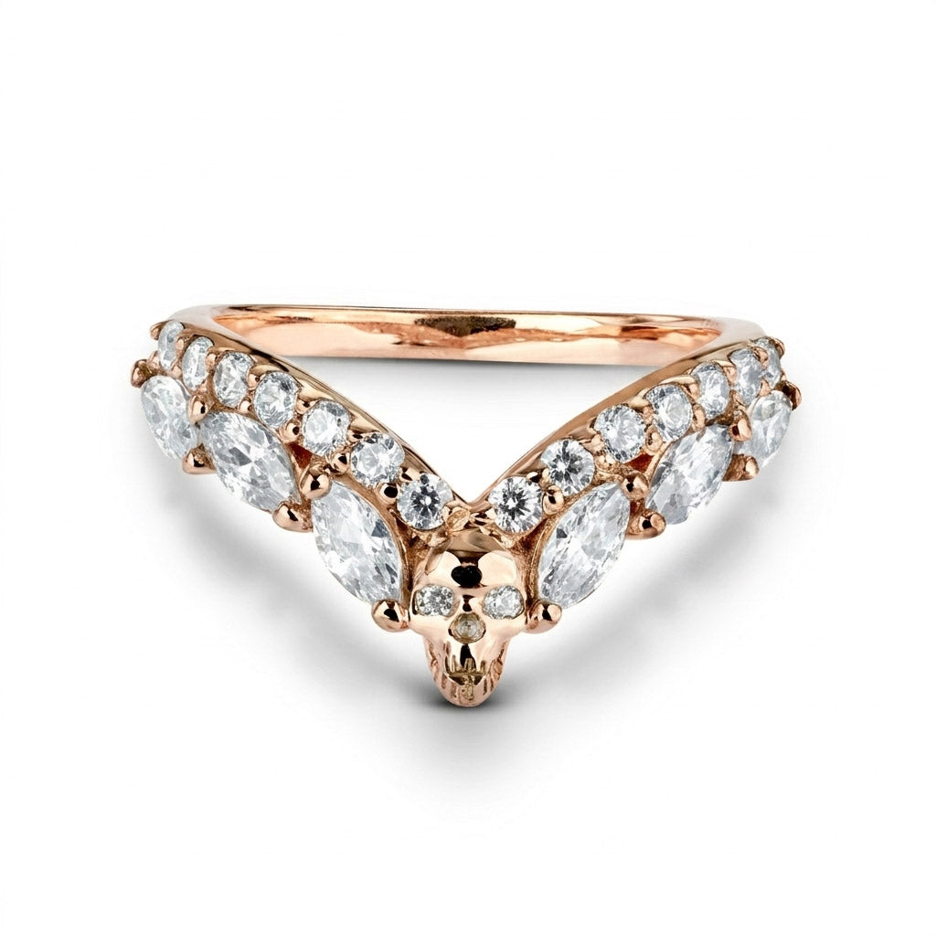 Rose gold V-shaped chevron ring enhancer featuring a detailed skull design and sparkling diamonds, perfect for gothic style wedding bands.