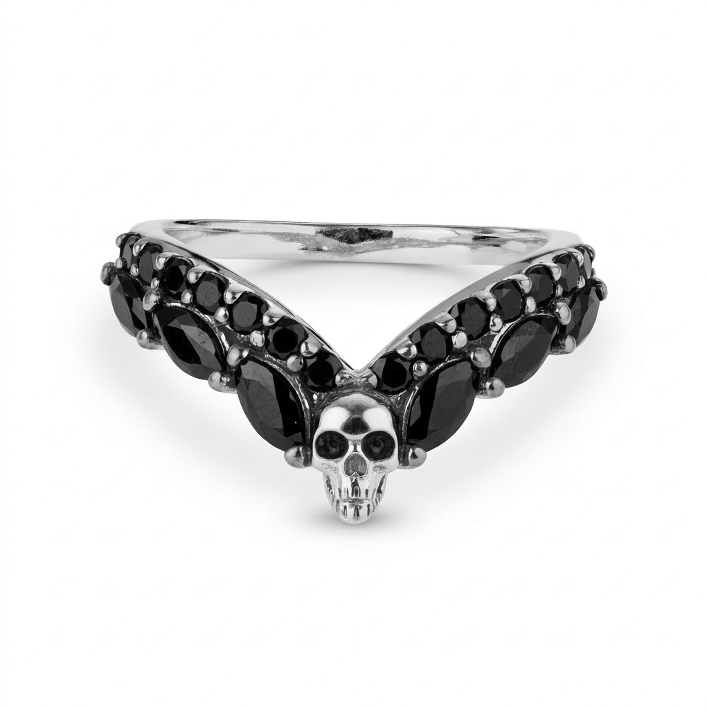 Gothic sterling silver skull wedding band, a V-shaped chevron ring enhancer set with black onyx gemstones for a bold and alternative bridal jewelry look.