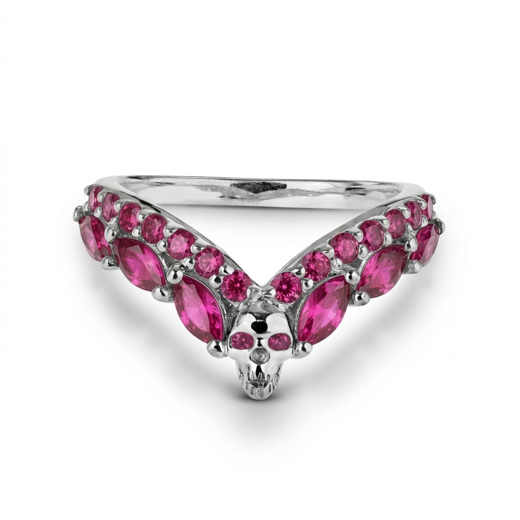 Sterling silver skull wedding band featuring a V-shaped chevron design with vibrant pink ruby gemstones, a standout piece of gothic jewelry.
