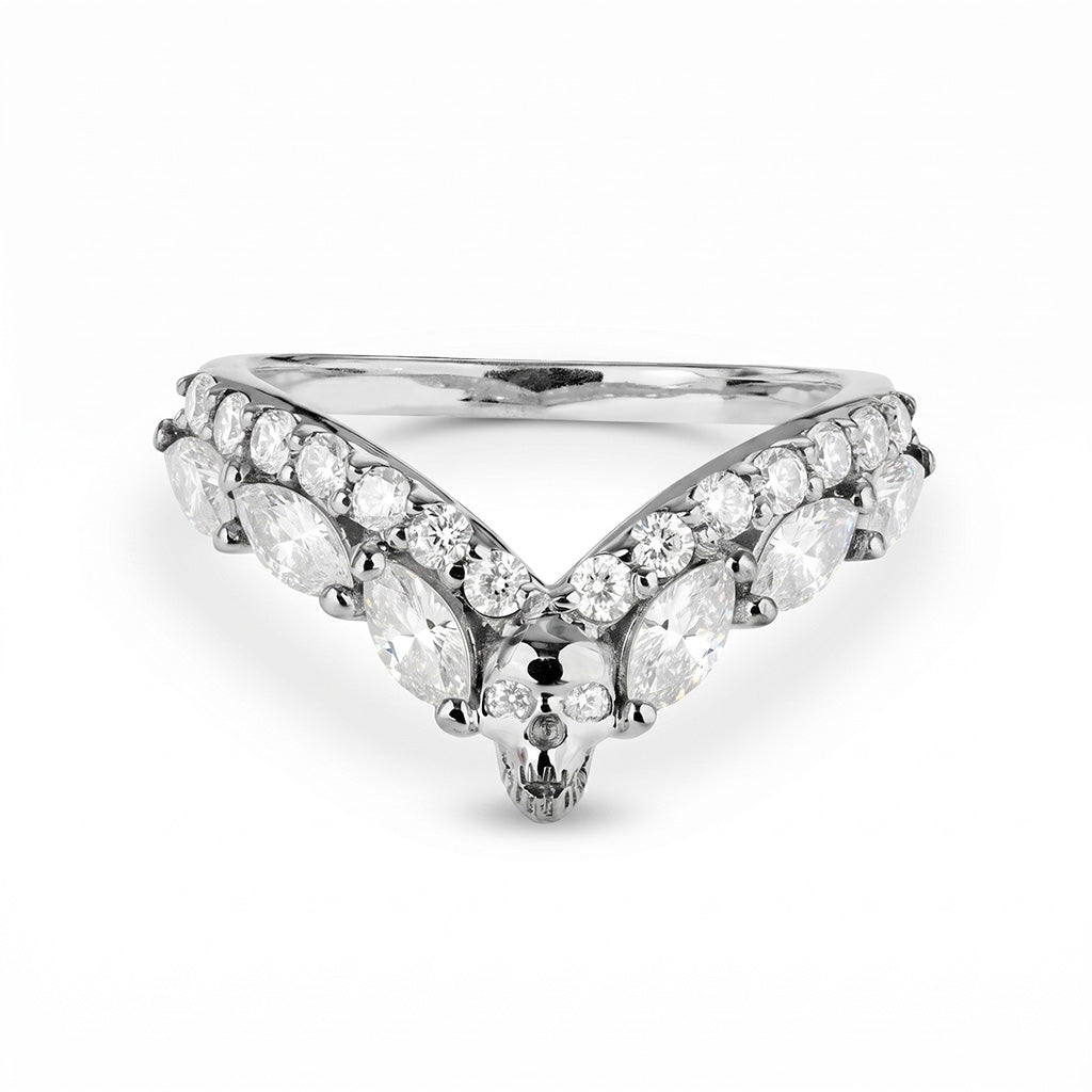Sterling silver V-shaped chevron ring enhancer with diamonds and a central skull, a classic yet gothic style wedding band choice.