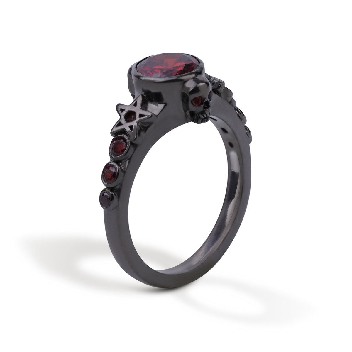 Black skull ring with pentagram star design and bezel set red garnet gemstones set in gun metal finished sterling silver