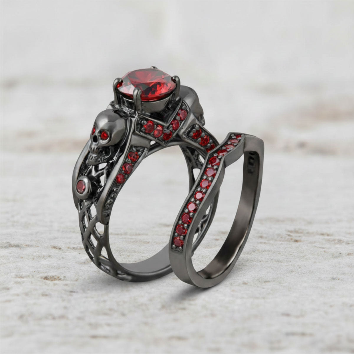 Black skull ring with red gemstones and matching stacking wedding band bridal set in gun metal finished sterling silver 