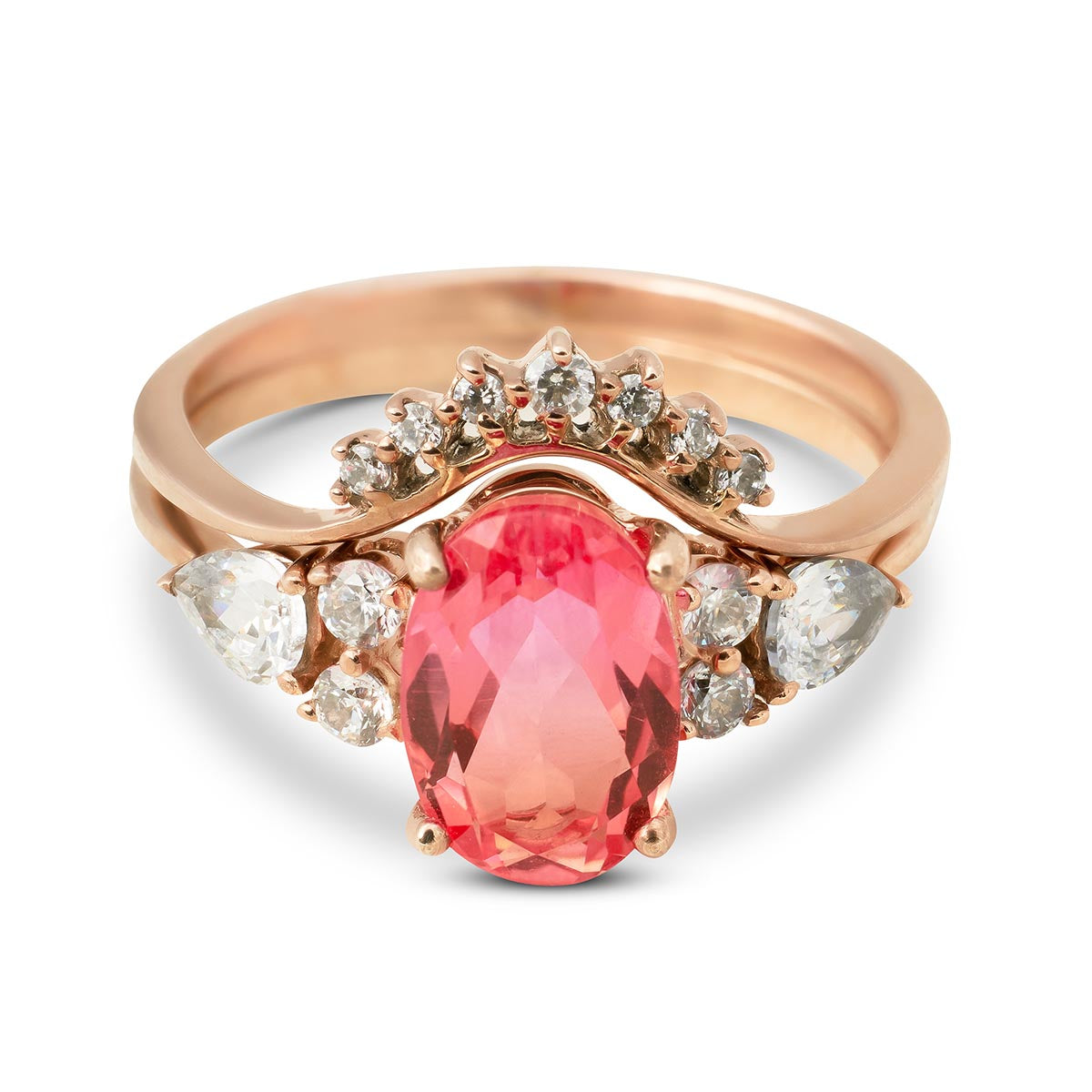 Elegant oval pink gemstone ring paired with a crown-style rose gold diamond enhancer band.