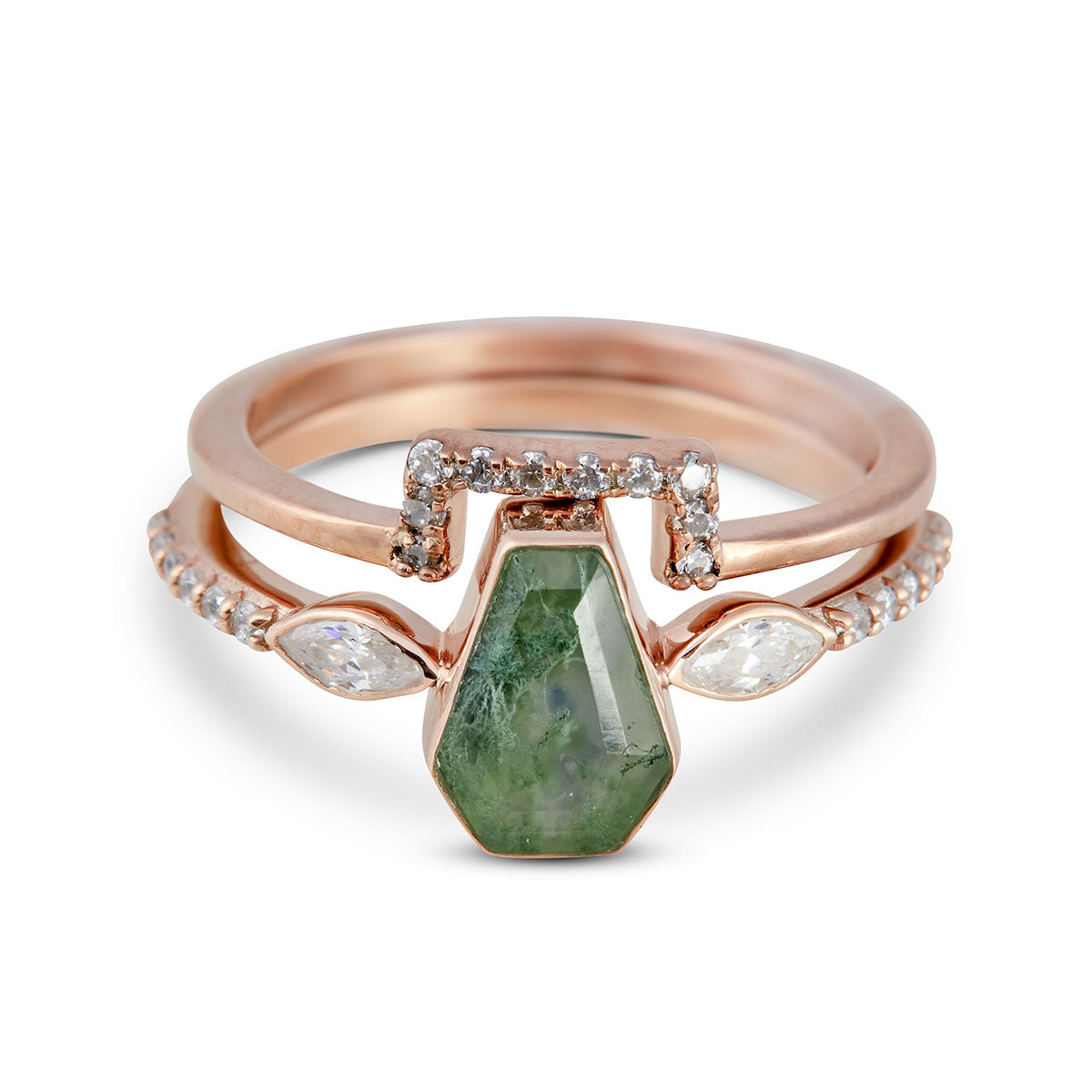 Rose gold ring with green stone and diamonds on a white background. 