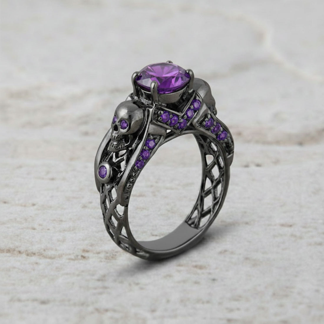 black skull ring with purple amethyst gemstones and criss cross mesh design band