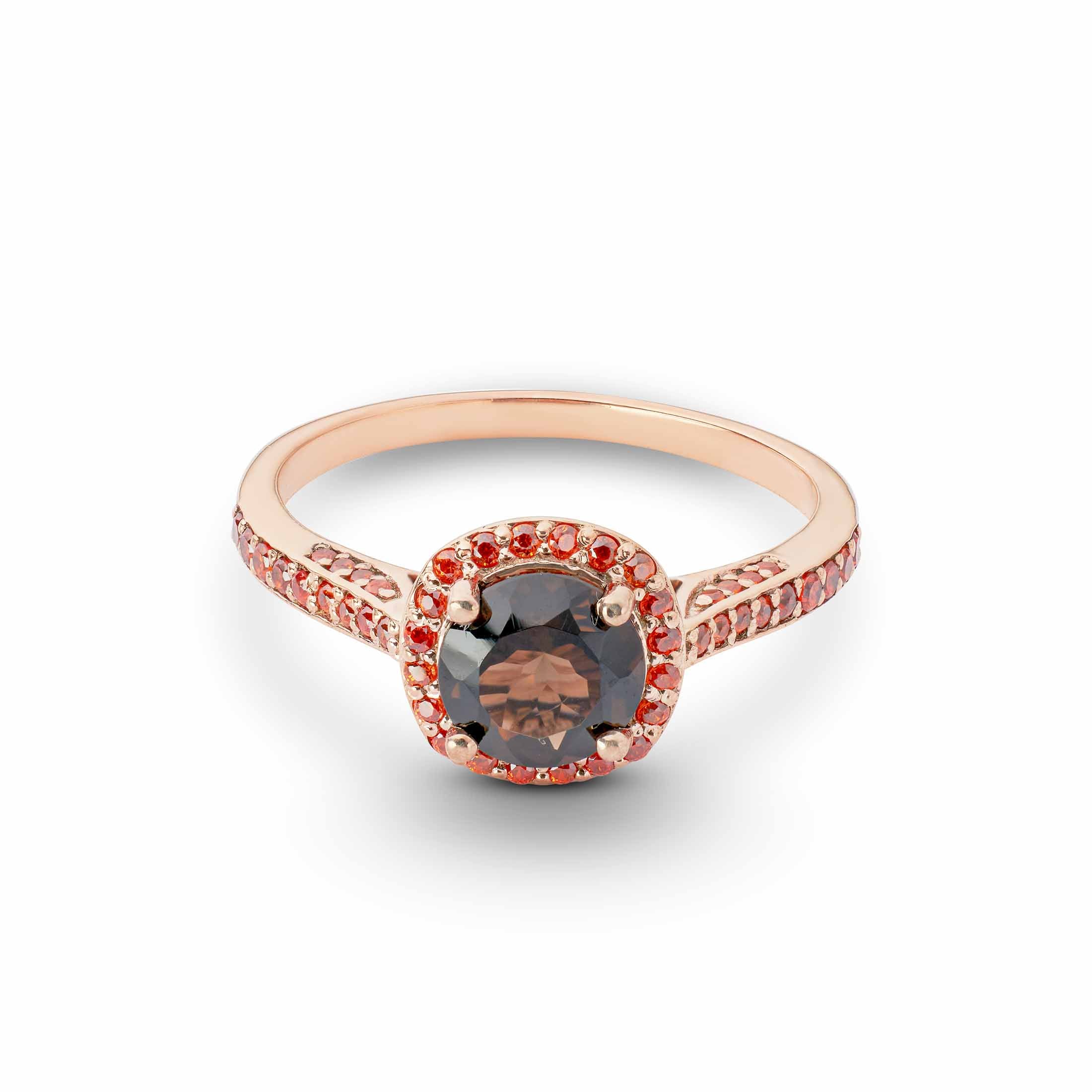 Round-cut smoky quartz ring in rose gold, surrounded by a halo and side-set of bright orange gems.