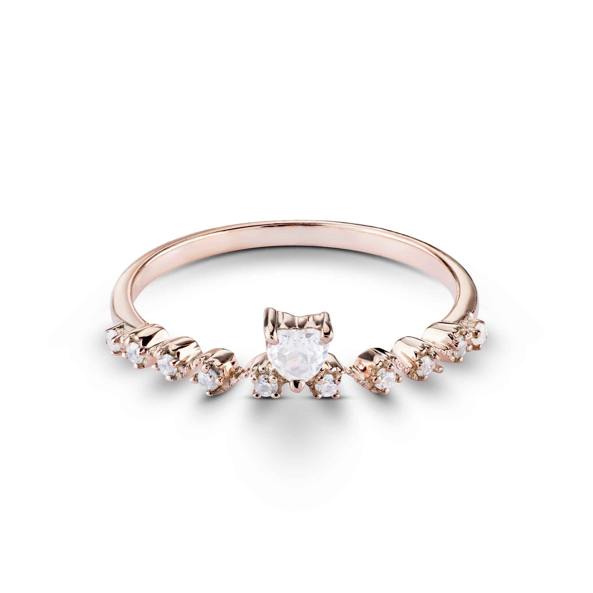 Elegant band ring featuring a central heart-shaped gemstone flanked by small round diamonds.