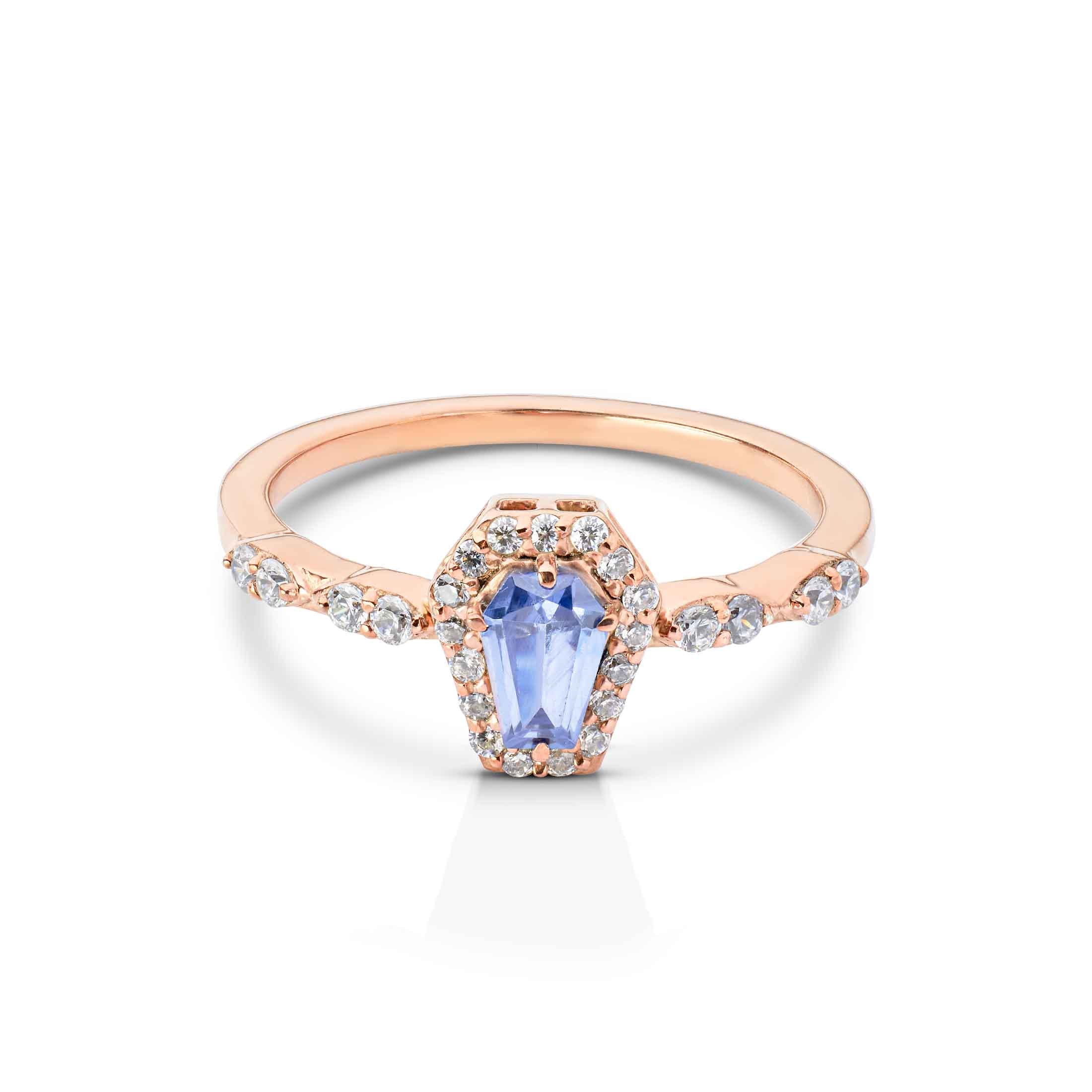 Pastel purple coffin-shaped gemstone ring set in rose gold with a sparkling diamond halo.