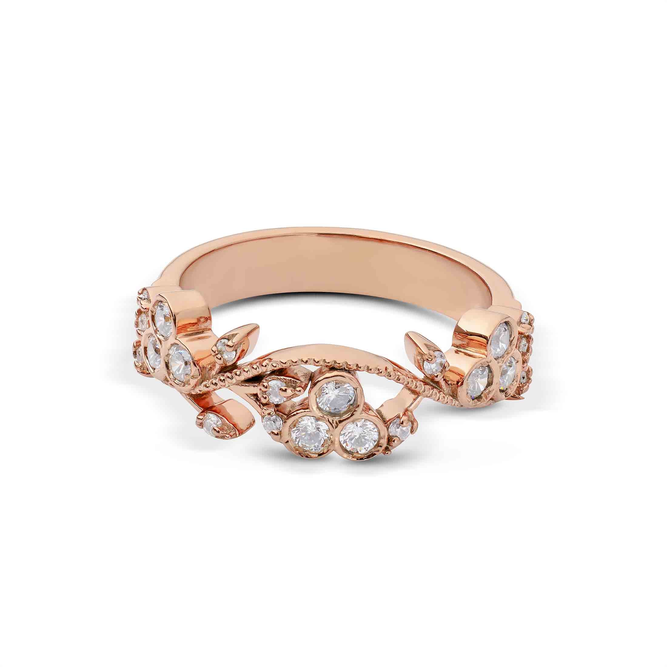 Rose gold ring with diamond accents on a white background