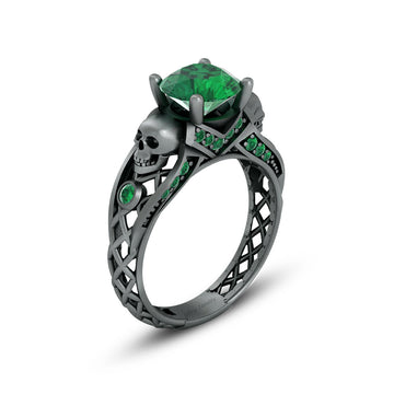 black skull ring with green emerald gemstones and criss cross mesh design band