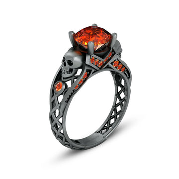 black skull ring with orange sapphire gemstones and criss cross mesh design band