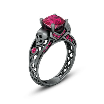 black skull ring with pink ruby gemstones and criss cross mesh design band