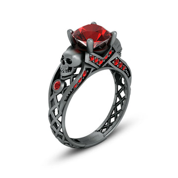 black skull ring with red garnet gemstones and criss cross mesh design band