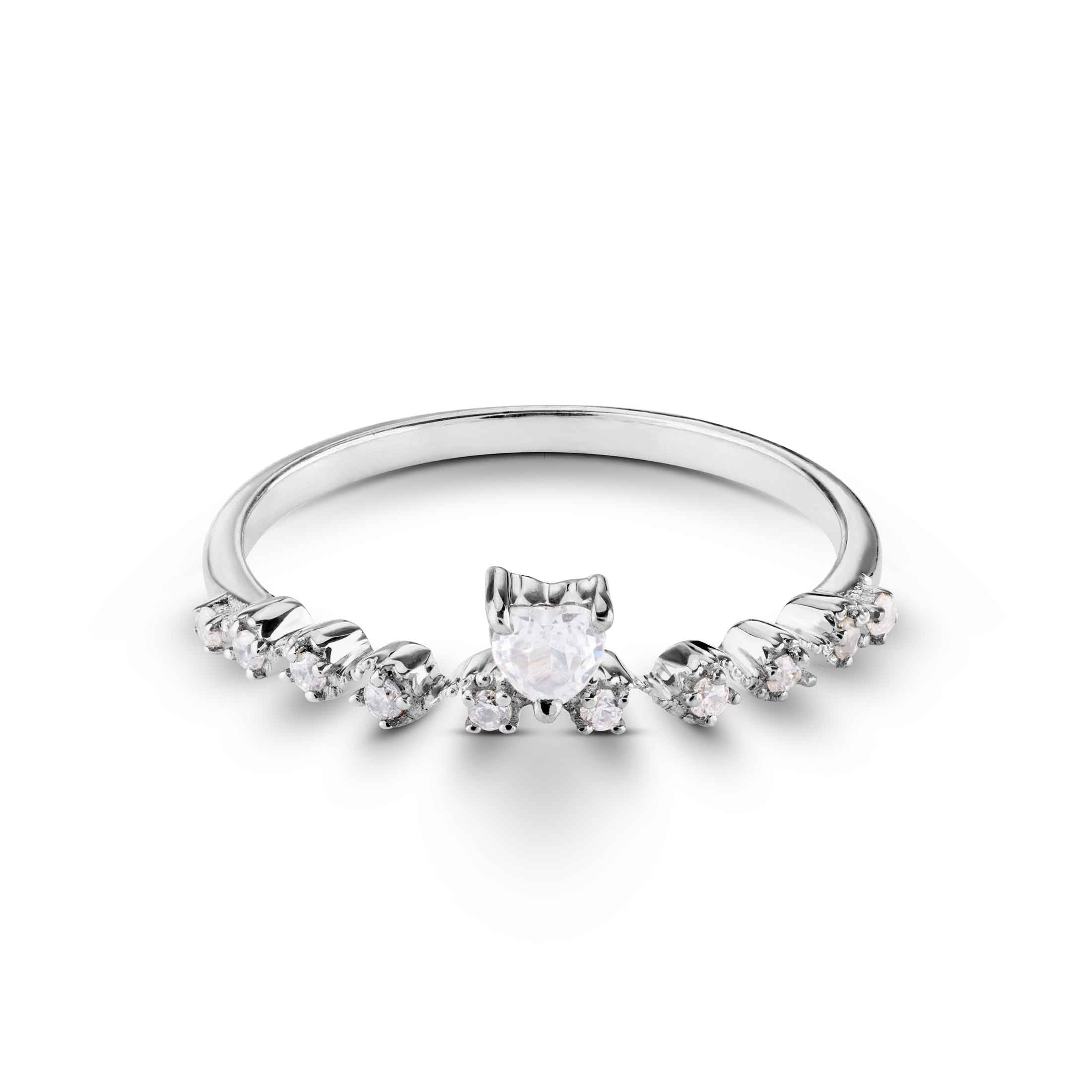 Front view of a polished silver ring showcasing a heart-cut stone nestled among tiny round jewels.
