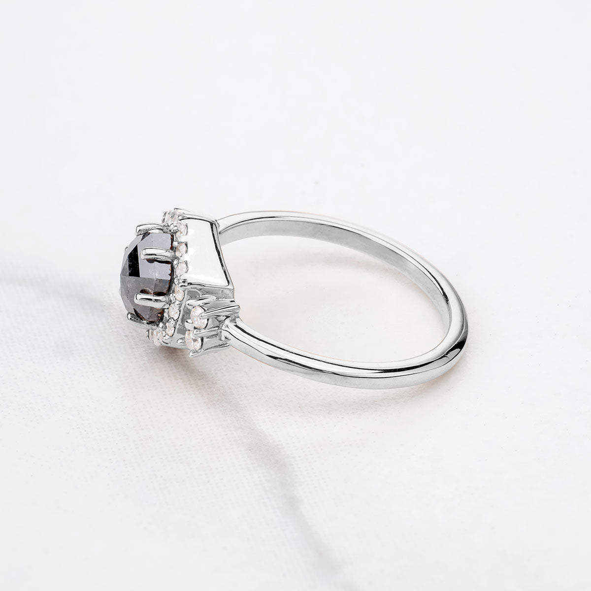 Side profile of a white gold hexagon salt and pepper diamond ring showing the raised setting, a unique proposal ring in solid 925 silver or gold