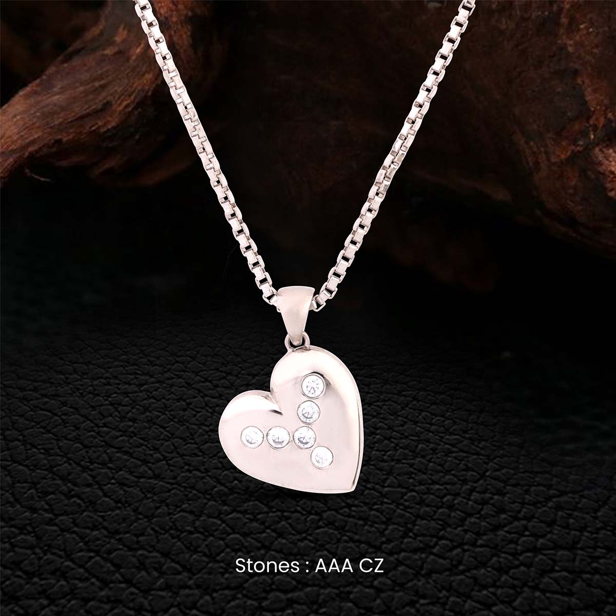 Sterling Silver Heart shaped pendant necklace with AAA CZ stones on a dark textured background