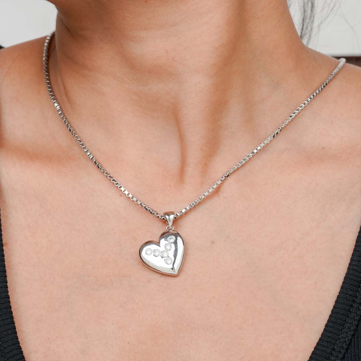 Sterling Silver heart shaped Pendant necklace on a person.