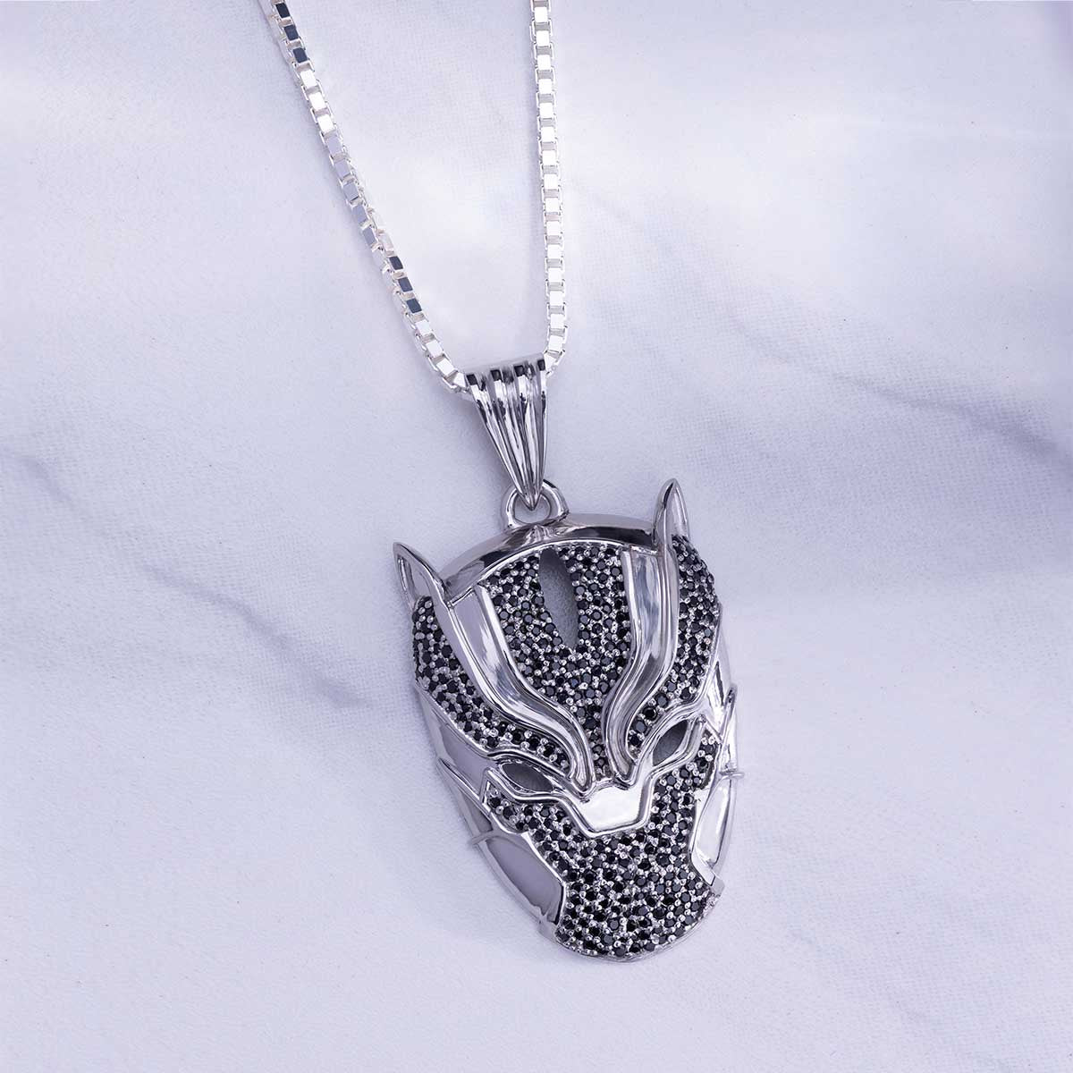Silver panther pendant necklace on a white background