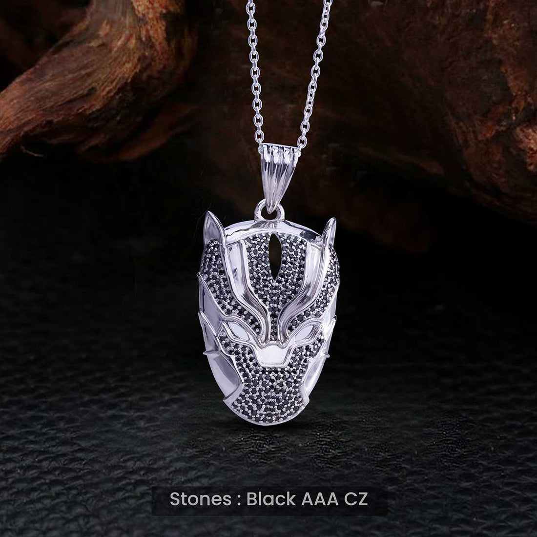 Silver panther pendant necklace with black stones on a dark textured background