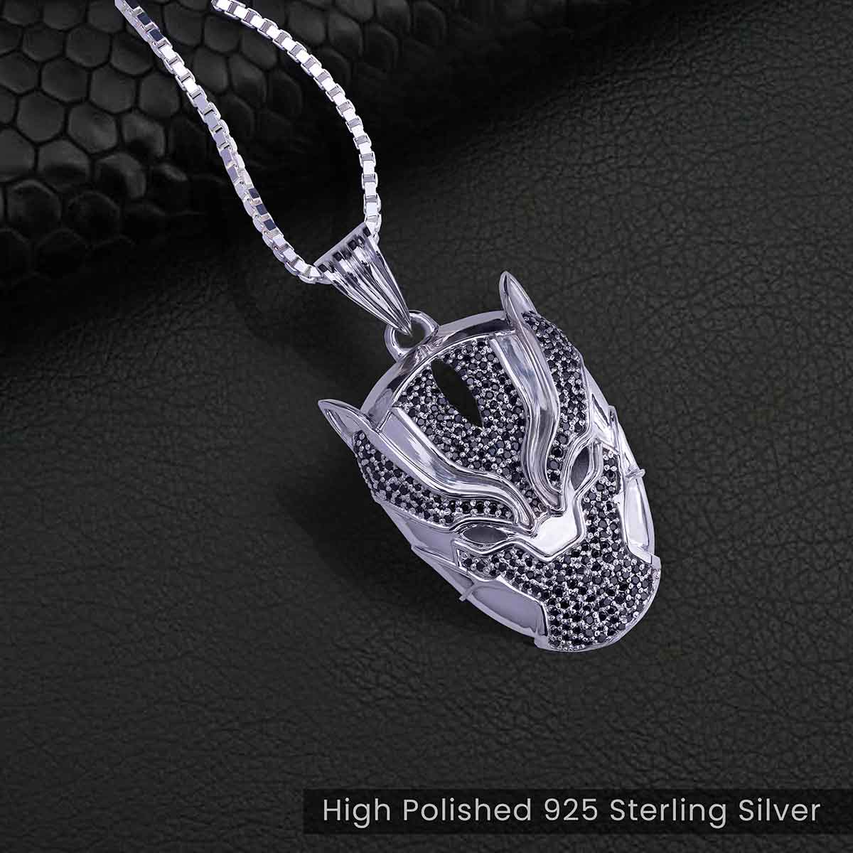 panther mask pendant on a dark textured background