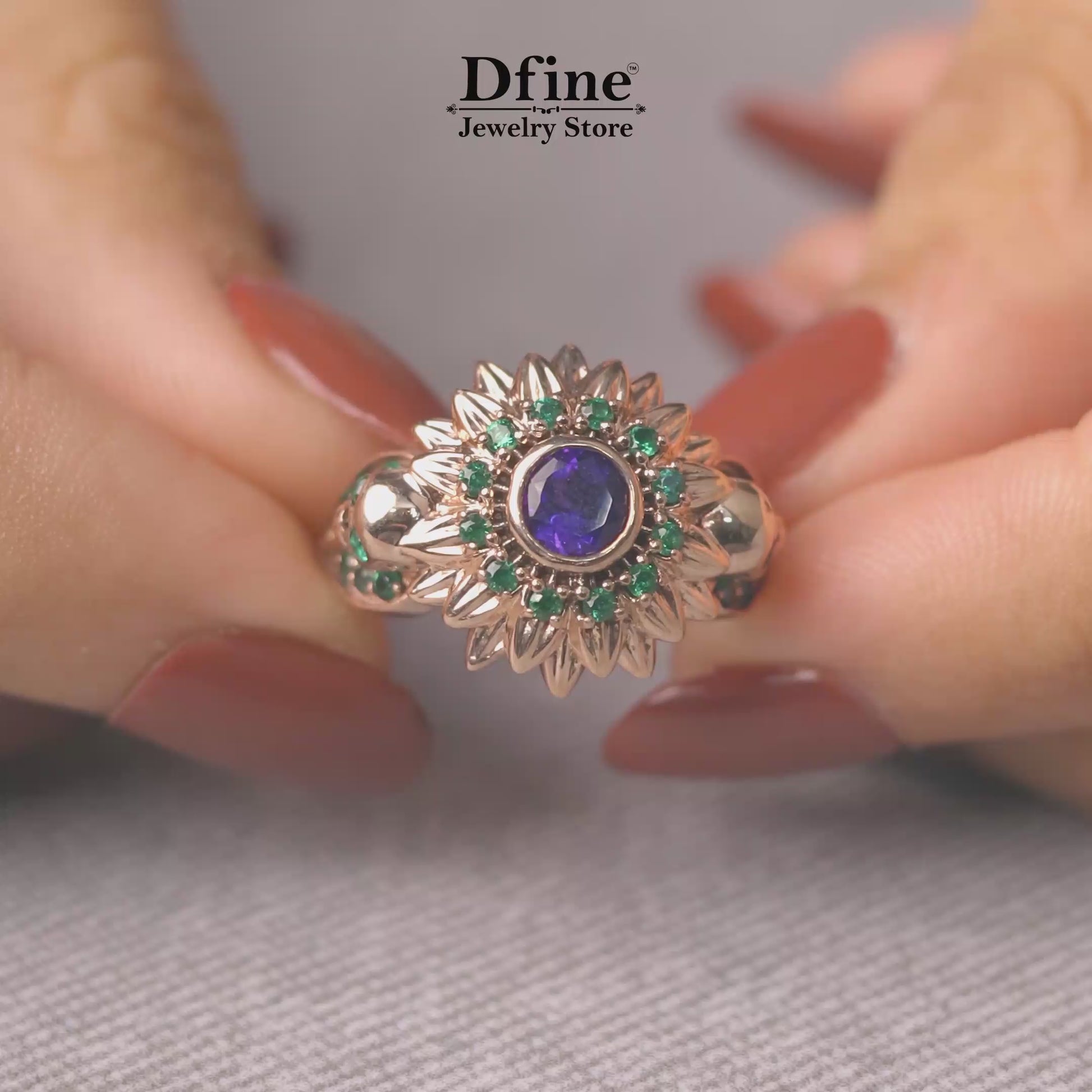 skull flower statement engagement ring with purple amethyst and green emerald gemstones in rose gold