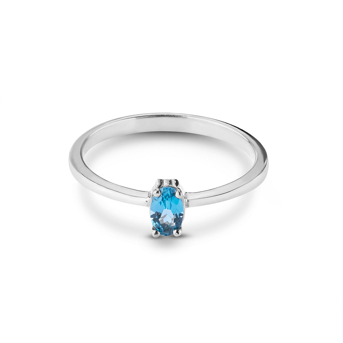Minimalist silver ring with a single oval blue sapphire held by a classic four-prong setting.